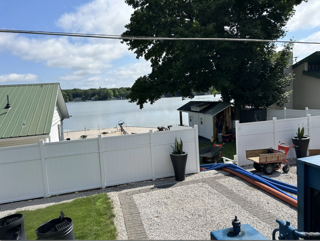 view from the street of turk lake during the beach sanding project in Greenville Michigan.